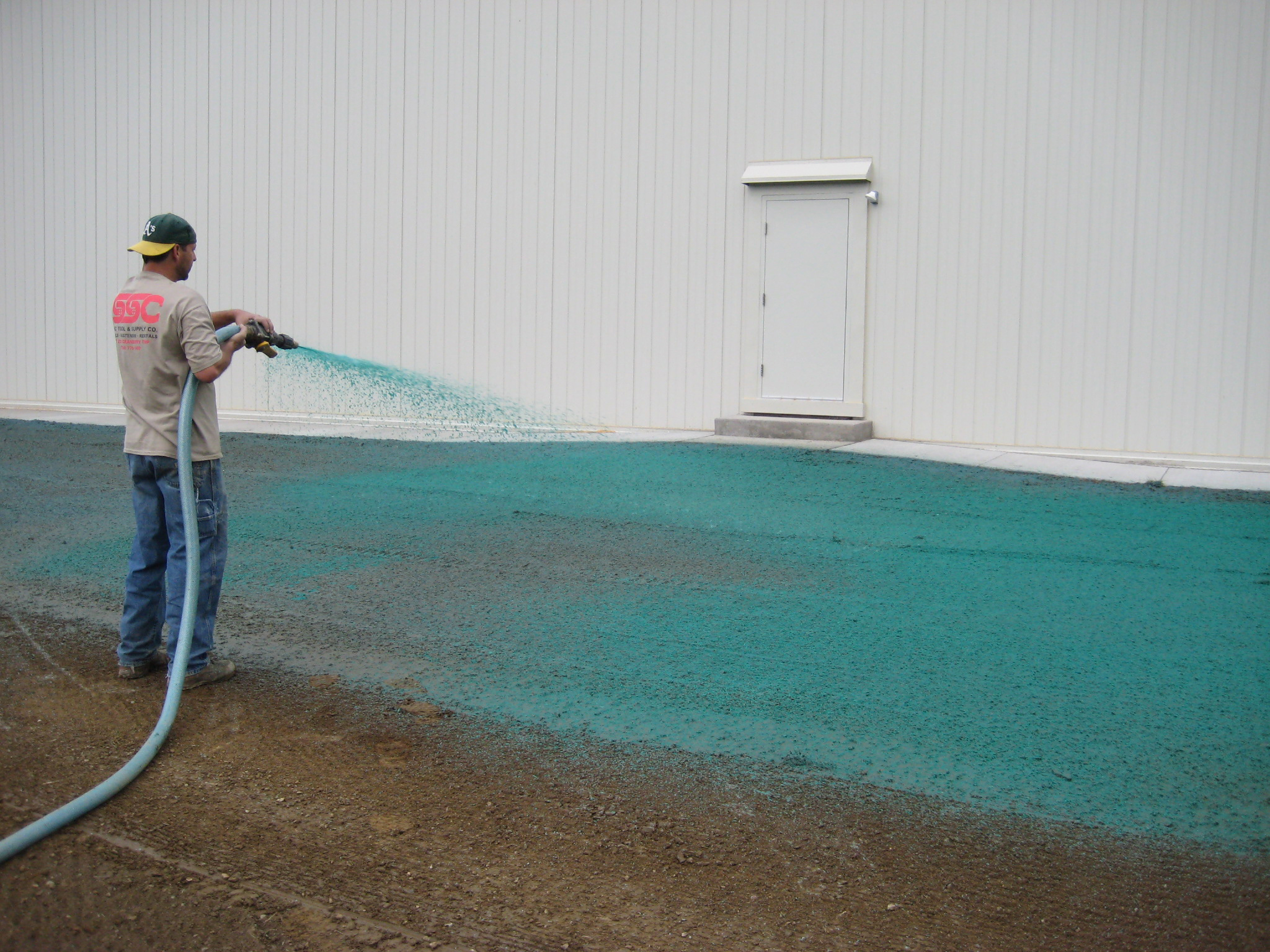 Warehouse being hydroseeded using wood hydromulch